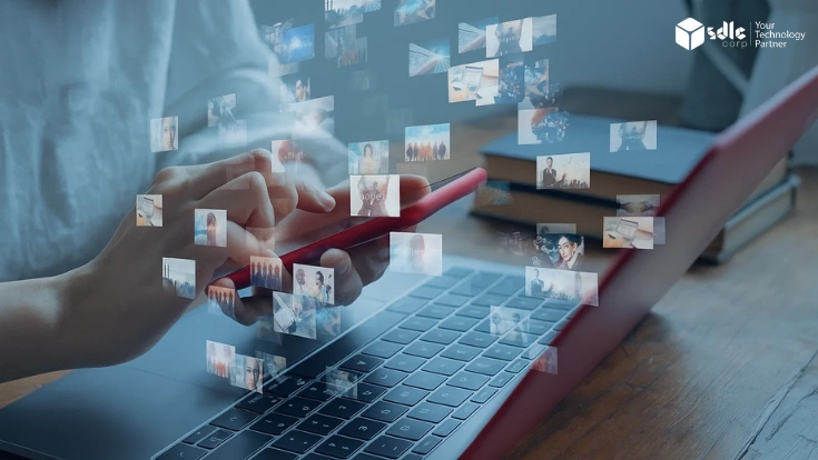 Person using a smartphone over a laptop with floating media thumbnails, symbolizing digital content generation and diffusion technology.