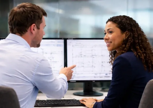 Aerospace staffing support with engineers reviewing technical designs