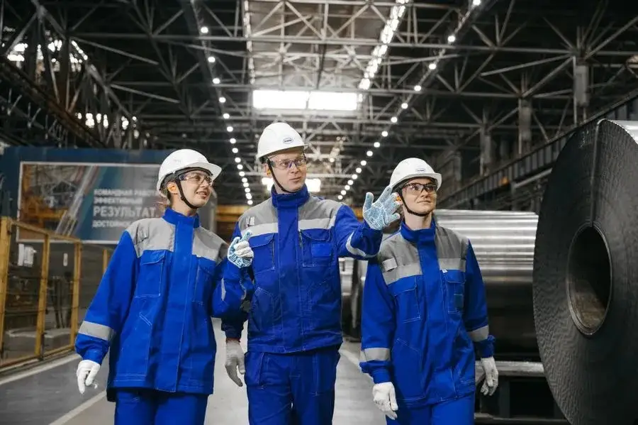 Industrial workers in safety gear at steel factory