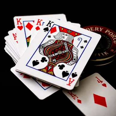 Online card game table with playing cards and chips during a live round.